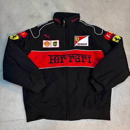 Black ferrari racing suit with red and white accents on a gray surface